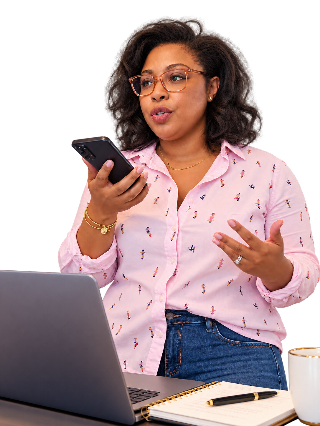 Tiffany Anthony speaking on the phone, with a laptop and notebook in front of her.